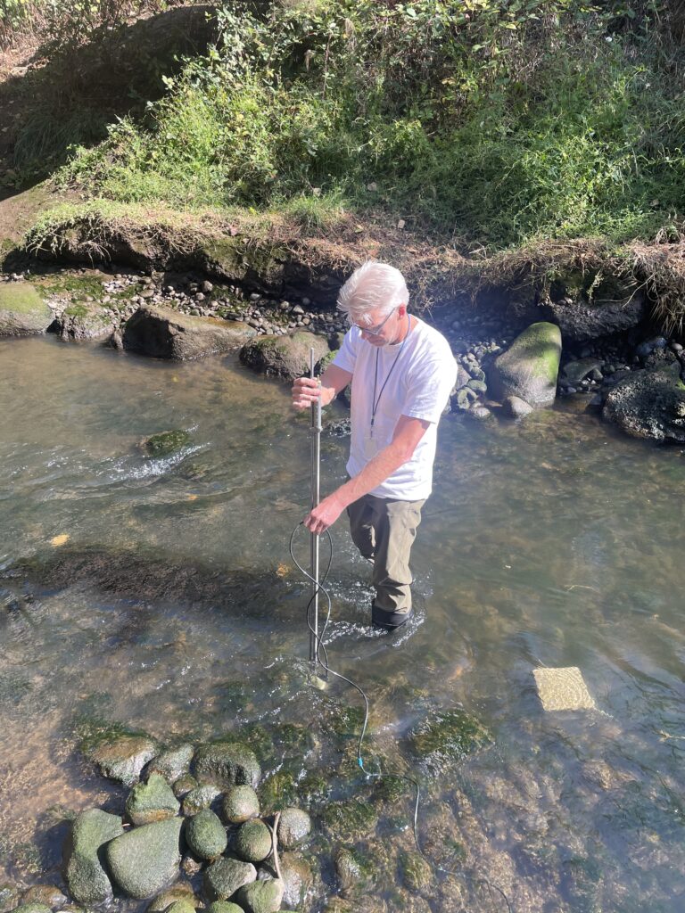 Center for Urban Waters environmental engineer Andy James measures the depth and flow of Hylebos Creek in the Tacoma Tideflats area. 