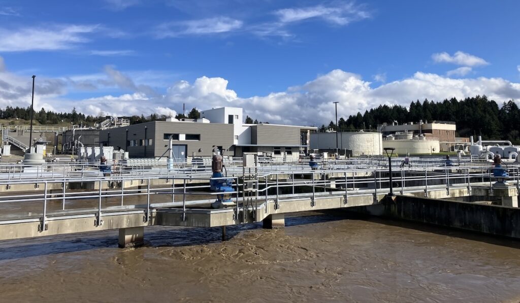 Operations center of Chambers Creek WWTP with treatment infrastructure visible in foreground.