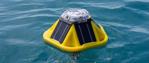 A yellow spotter wave bouy floating on surface of water