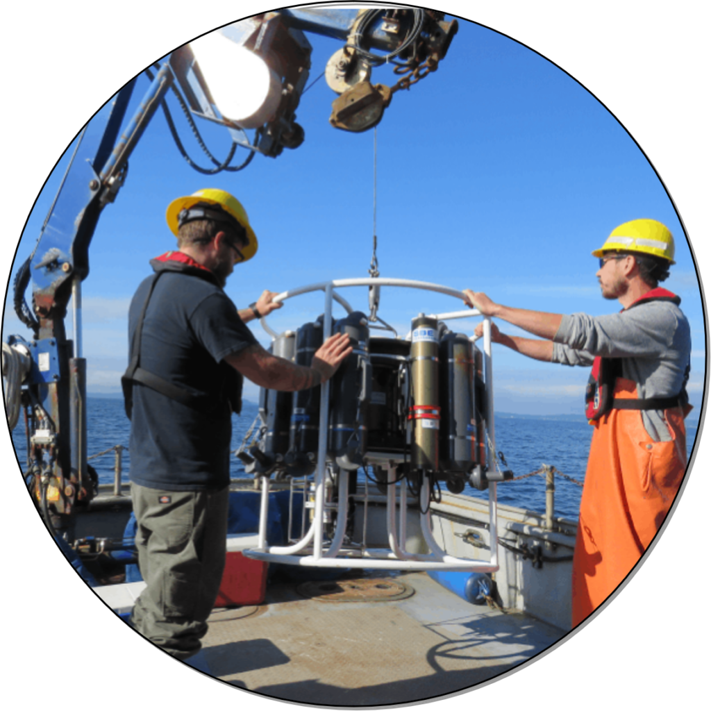 Two marine scientists deploying a CTD, an oceanographic measurement device.